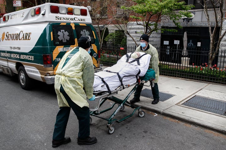 A patient is loaded into the back of an ambulance by emergency medical workers outside Cobble Hill Health Center, Friday, April 17, 2020, in the Brooklyn borough of New York.