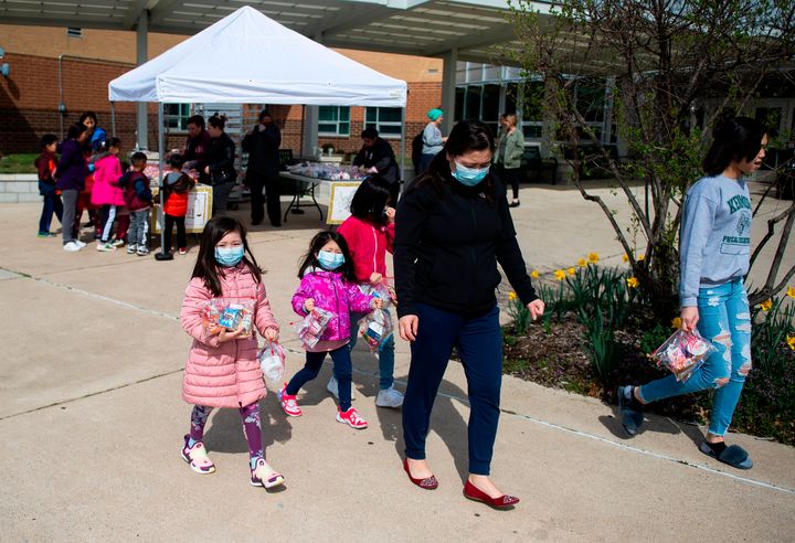 Children pick up free lunches at Kenmore Middle School in Arlington, Virginia, on March 16, after schools in the area closed due to the coronavirus outbreak.