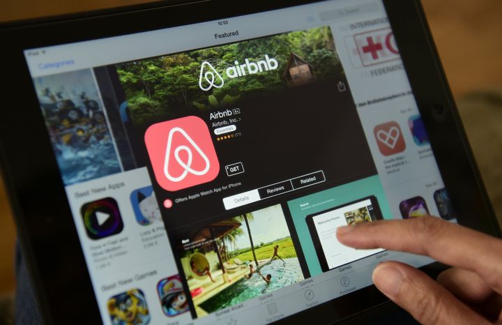 A woman browses the site of home sharing giant Airbnb on a tablet in Berlin, April 28, 2016. Airbnb is in a fight for its life amid the COVID-19 outbreak, but that could be good news for renters and homebuyers struggling with affordability.