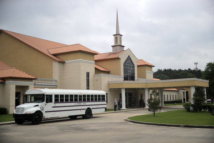 Busloads of congregants arrive at Life Tabernacle Church before Easter services on April 12, 2020.