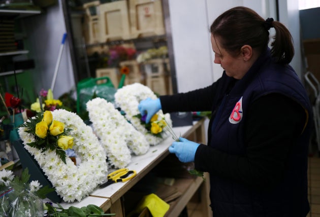 Florist Emma Glynn making a funeral tribute in Barbican as the spread of coronavirus disease (COVID-19) continues in London, Britain, April 15, 2020.