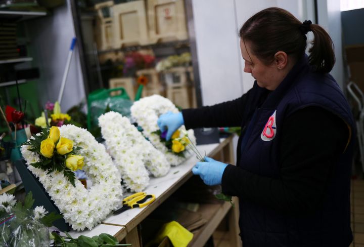 Florist Emma Glynn making a funeral tribute in Barbican as the spread of coronavirus disease (COVID-19) continues in London, Britain, April 15, 2020.