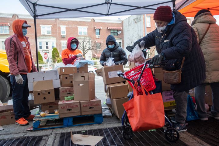 Staff and volunteers distribute food at The Campaign Against Hunger food pantry, Thursday, April 16, 2020, in the Bedford-Stuyvesant neighborhood of the Brooklyn borough of New York. (AP Photo/Mary Altaffer)