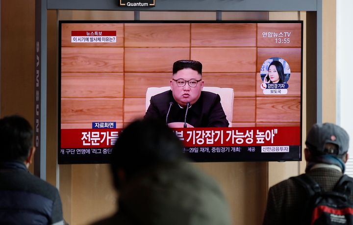 People watch a TV screen showing a news program reporting about North Korea's firing projectiles with a file footage of North Korean leader Kim Jong Un at the Seoul Railway Station in Seoul, South Korea, Monday, March 2, 2020. (AP Photo/Lee Jin-man)