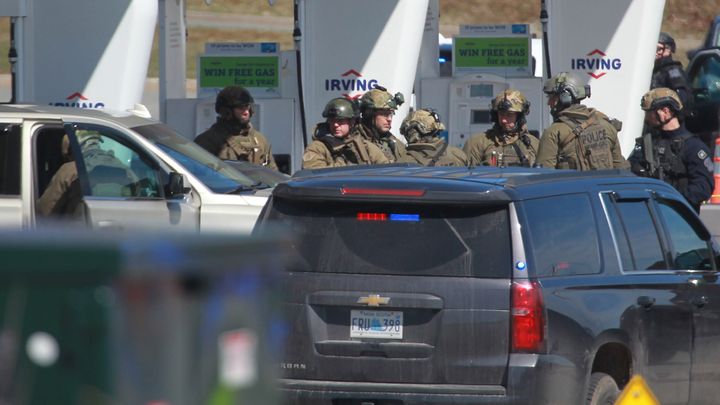 RCMP officers prepare to take a suspect into custody at a gas station in Enfield, N.S. on April 19, 2020.