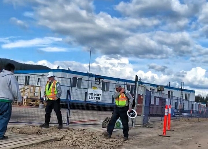 Workers walk past the work camp inside the Morice River access point in Wet'suwet'en territory in the fall of 2019.