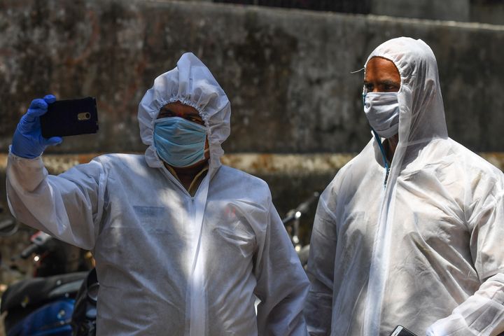 Policemen in hazmat suits at a COVID-19 coronavirus testing drive inside the Dharavi slums in Mumbai.
