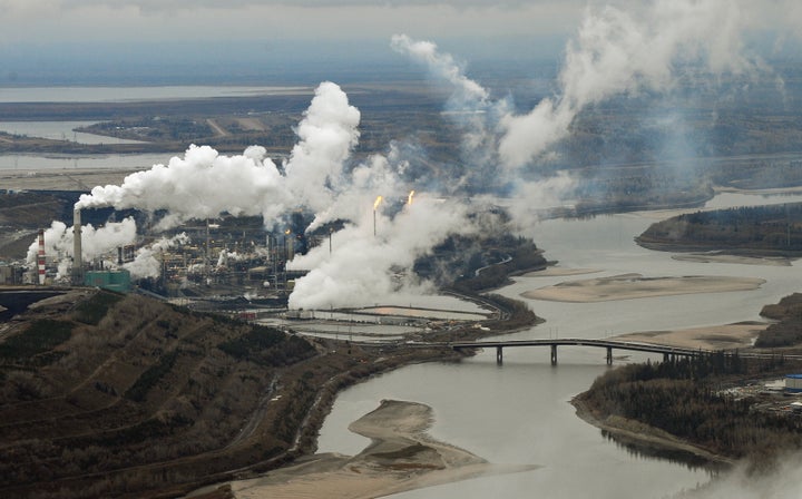 This file photo shows an aerial view of the Suncor oil sands extraction facility on the Athabasca River near Fort McMurray, Alta., Oct. 23, 2009. Canadian oil prices have turned negative amid yet another major decline in global oil prices amid the COVID-19 pandemic.