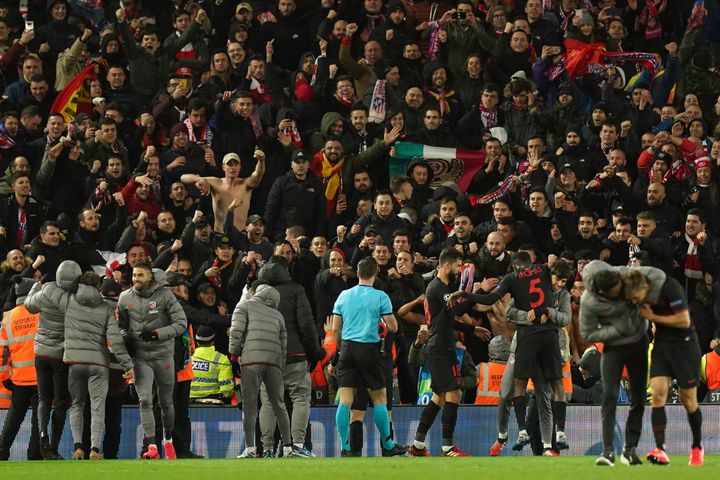 Atletico Madrid players celebrate with fans at the end of the match against Liverpool on March 11.