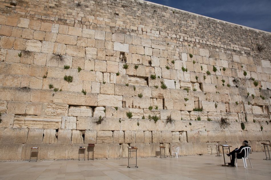 A man prays at the nearly empty Western Wall in the old city on April 6, 2020, in Jerusalem.