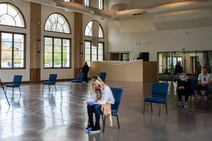 A woman prays during a communion service at the Godspeaker Calvary Chapel sanctuary on April 5, 2020, in Thousand Oaks, California.