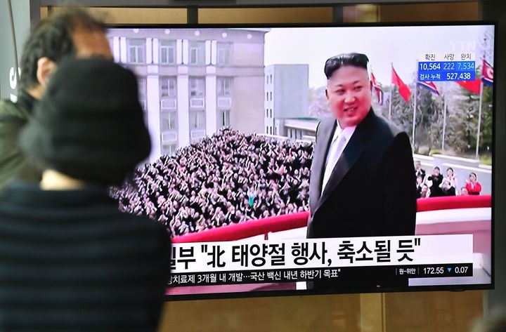 People watch a television news broadcast showing file footage of North Korean leader Kim Jong Un, at a railway station in Seoul on April 14, 2020.