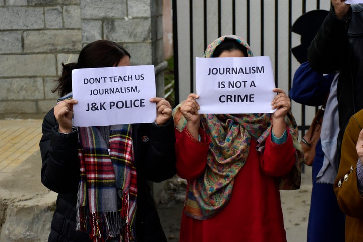 Kashmiri journalists hold placards during a protest in Kashmir on 18 December 2019.