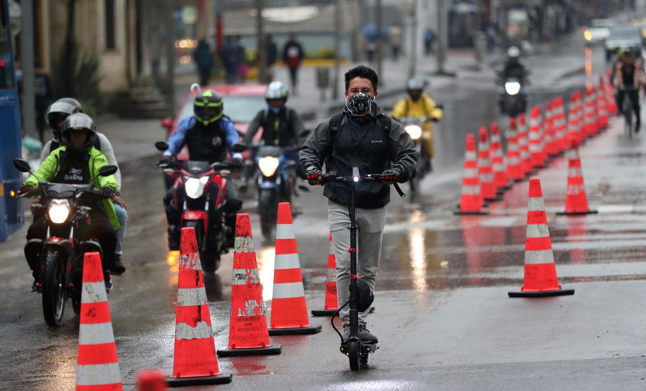 A man riding an electric scooter in a bike lane in Bogotá, Colombia, on March 16, 2020. Officials in the city have expanded bike routes, encouraging people to abandon crowded public transportation to lower the risk of catching the coronavirus.