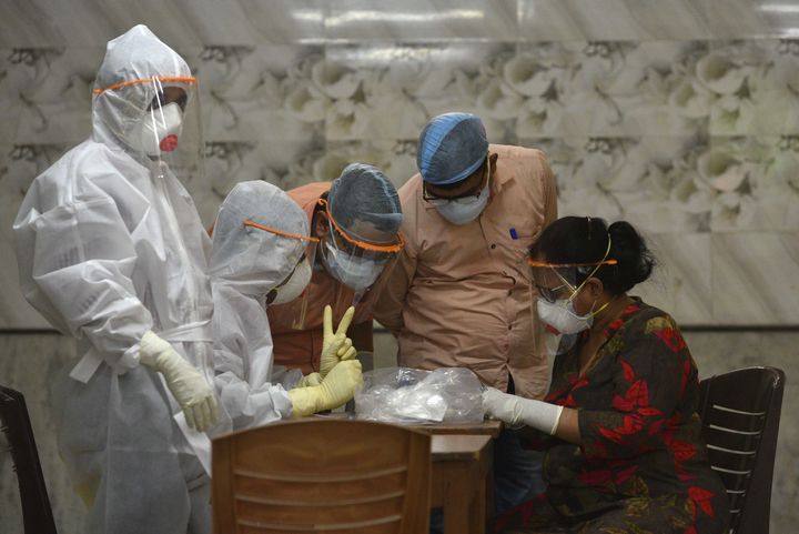 Medical workers prepare to take samples for antibody tests at Belgachia bustee, on April 20, 2020 in Kolkata.