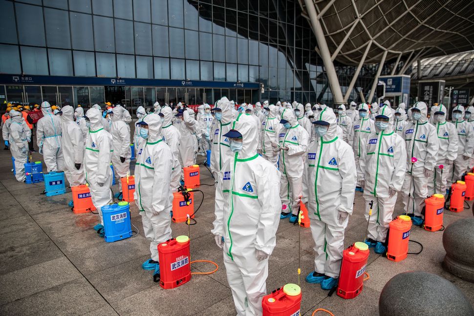 Workers prepare to spray disinfectant at the Wuhan Railway Station in Wuhan, China on March 24, 2020. The city in central Chi