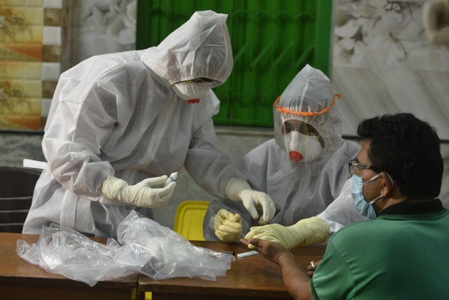 A medical worker takes a sample for antibody test on April 20, 2020 in