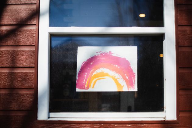 Children's rainbow drawings inspire hope and cheer up weary neighbours during the pandemic.