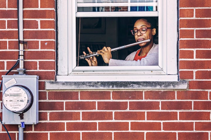 One of Gruenwald's subjects seen playing the flute through her window. 