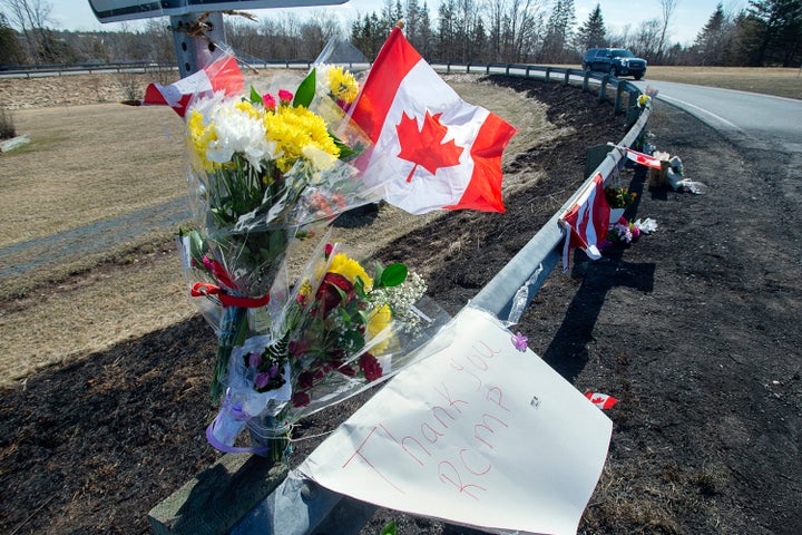 A memorial pays tribute to Royal Canadian Mounted Police Constable Heidi Stevenson, a mother of two and a 23-year veteran of the force, along the highway in Shubenacadie, Nova Scotia, on Tuesday, April 21, 2020. (Andrew Vaughan/The Canadian Press via AP)