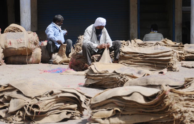  Laborer repairing gunny bags use for carrying Wheat at new grain market lockdown on April 15, 2020...