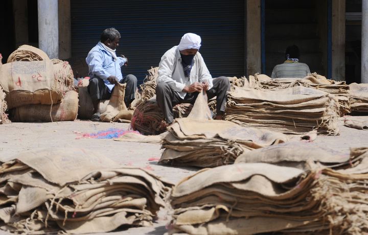  Laborer repairing gunny bags use for carrying Wheat at new grain market lockdown on April 15, 2020 in Patiala, India. (Photo by Bharat bhushan Hindustan Times via Getty Images)