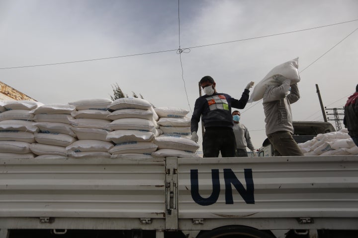 Palestinian employees at the U.N. Relief and Works Agency for Palestinian Refugees prepare food aid rations that will be delivered to people's homes due to the COVID-19 pandemic.