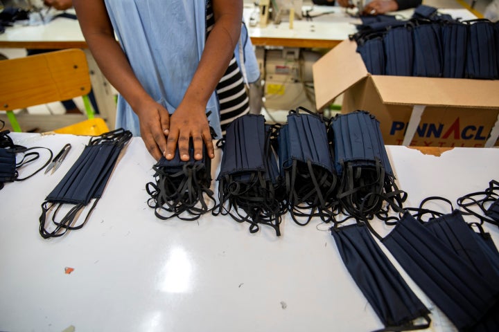 A factory worker counts face masks at the Sonapi Industrial Park in Port-au-Prince, Haiti.