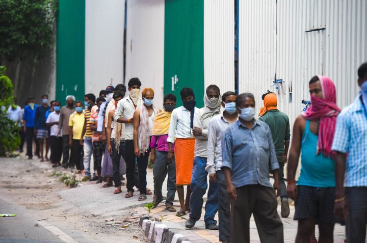 NEW DELHI, INDIA - APRIL 14: Stranded migrant workers and homeless people queue to collect food at Safdarjung Enclave during lockdown, on April 14, 2020 in New Delhi, India. (Photo by Amal KS/Hindustan Times via Getty Images)