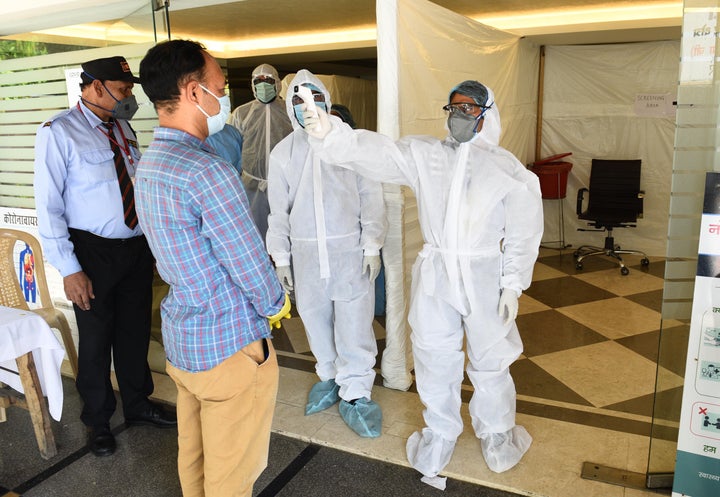 A journalist undergoes thermal screening during a health camp organised for COVID-19 tests at West Patel Nagar on April 22, 2020 in New Delhi.