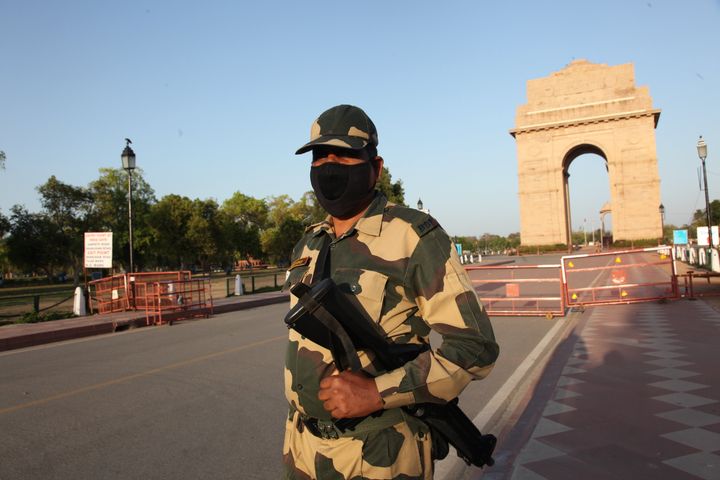 Security guards are posted at India Gate on April 5, 2020 in New Delhi. The air quality has greatly improved in the city. 