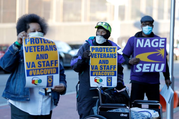 Clarence Shields, center, an Army veteran, pickets with a small group of activists from the American Federation of Government Employees local 424 and the National Association of Government Employees local R3-19 outside the Baltimore VA Medical Center on April 22, 2020.