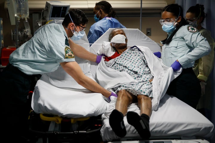In this Monday, April 20, 2020, file photo, emergency medical technicians transport a patient from a nursing home to an emergency room bed at St. Joseph's Hospital in Yonkers, N.Y. (AP Photo/John Minchillo, File)