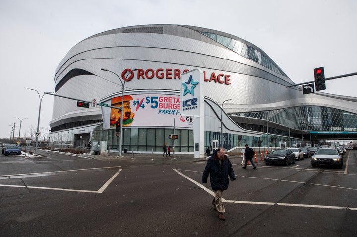 A pedestrian walks outside Rogers Place in Edmonton, Alta., on March 12, 2020. 