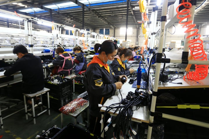 SUIXI, CHINA - APRIL 17 2020: People work in a factory of motorbike and scooter parts in Suixi county in central China's Anhui province Friday, April 17, 2020.