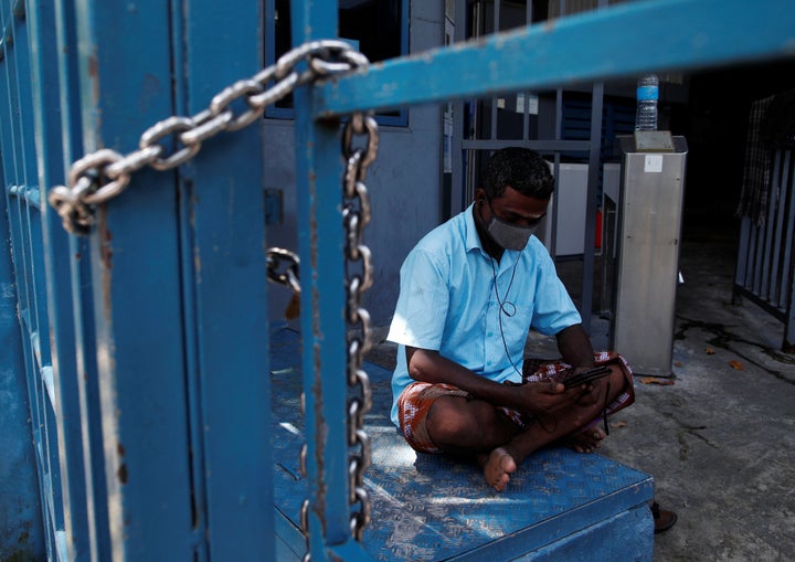 A migrant worker pictured in a dormitory in Singapore on April 22, 2020. Some workers have compared their coronavirus containment to being in "prison."