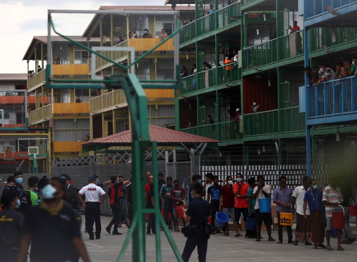 Migrant workers lining up to collect food at the Punggol S11 dormitory in Singapore during the coronavirus outbreak on April 6, 2020. 