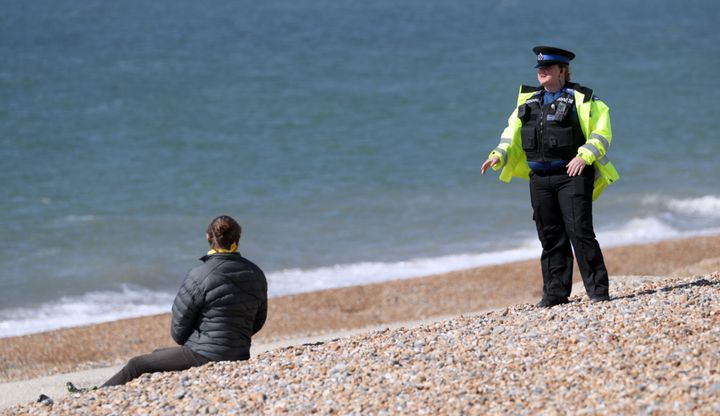 An individual is questioned on Brighton seafront