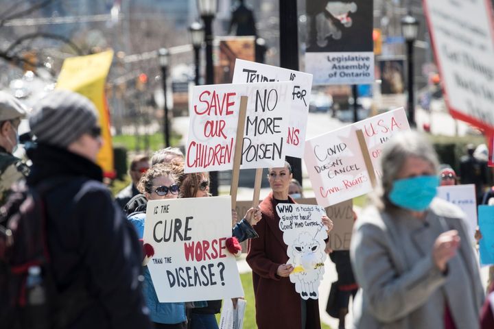 Demonstrators gather during a protest to end the shutdown due to COVID-19 at Queen's Park in Toronto on Saturday.