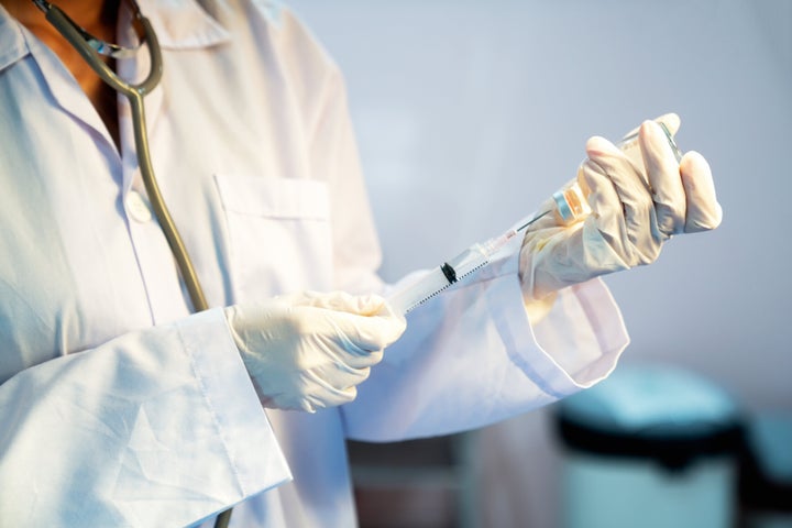 Close-Up Of Doctor Filling Medical Injection.