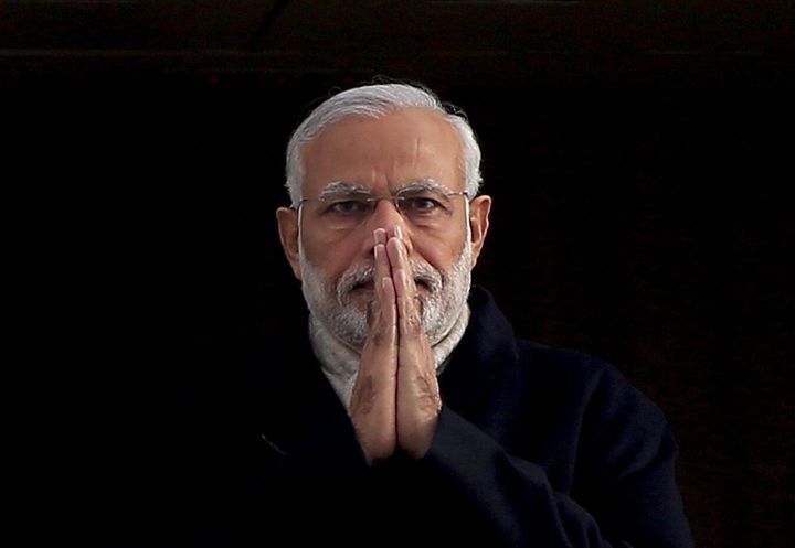 India's Prime Minister Narendra Modi holds up his hands in a "namaste", an Indian gesture of greeting, as he arrives at Heathrow Airport for a three-day official visit, in London, November 12, 2015. 