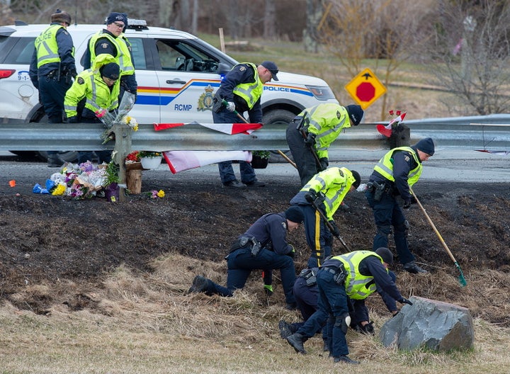 RCMP investigators search for evidence at the location where Const. Heidi Stevenson was killed along the highway in Shubenacadie, N.S. on Thursday.