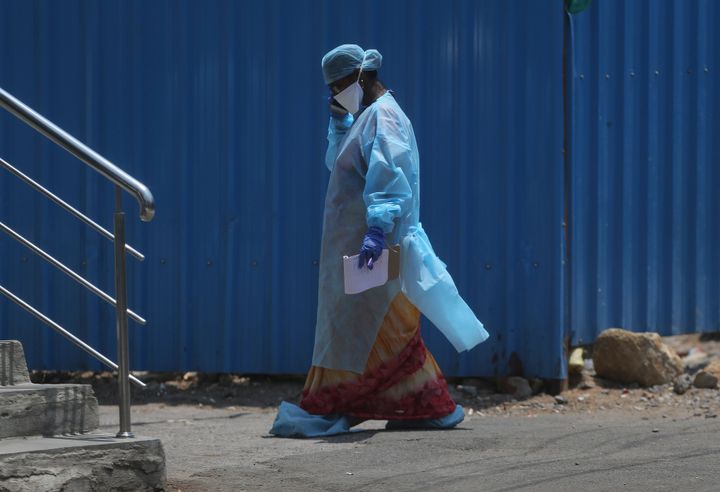 A health worker walks inside a containment zone to collect details during lockdown to prevent the spread of new coronavirus in Hyderabad, April 26, 2020. 