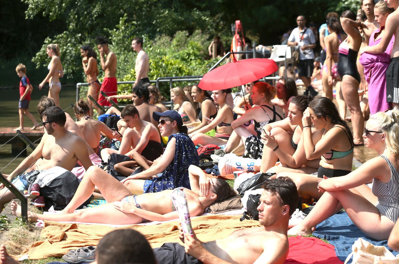 People sunbathing at the mixed bathing pond on Hampstead Heath in 2018.