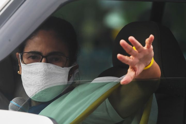 Chief minister of West Bengal Mamata Banerjee waves as she delivers a speech from her car in Kolkata on April 23, 2020.