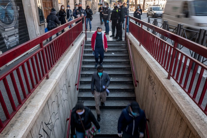 People walk to the San Giovanni metro station in Rome on April 24 during a three-hour testing period of new measures designed to reduce congestion on public transportation, April 24.