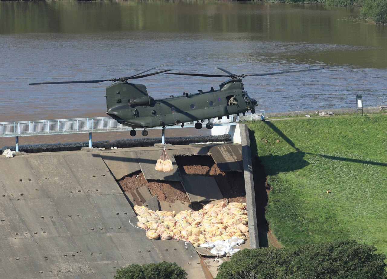 An RAF Chinook helicopter flying in sandbags to help repair the dam at Toddbrook reservoir near the village of Whaley Bridge in Derbyshire after it was damaged by heavy rainfall last year.