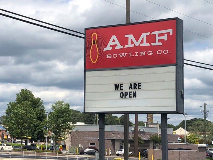 The sign outside the AMF bowling alley in Conyers, Ga., displays a message Friday, April 24, 2020, in Conyers, Ga. Like many