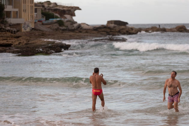 SYDNEY, AUSTRALIA - APRIL 28: Swimmers return to Bondi beach on April 28, 2020 in Sydney, Australia. Waverley Council reopened Bondi, Bronte and Tamarama beaches today, with COVID-19 social distancing rules still in place. The beaches will be open from 7am to 5pm for swimmers and surfers on weekdays, but will remain closed on weekends. Several beaches in Sydney's Eastern suburbs were closed March 28, after large crowds were seen gathering at Bondi Beach despite social distancing orders in place to slow the spread of COVID-19. (Photo by Brook Mitchell/Getty Images)