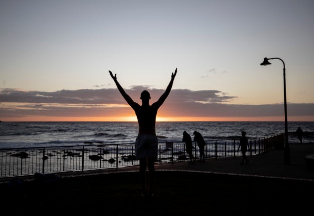 SYDNEY, AUSTRALIA - APRIL 28: A person practices Yoga at Bronte Beach on April 28, 2020 in Sydney, Australia. Waverley Council reopened Bondi, Bronte and Tamarama beaches today, with COVID-19 social distancing rules still in place. The beaches will be open from 7am to 5pm for swimmers and surfers on weekdays, but will remain closed on weekends. Several beaches in Sydney's Eastern suburbs were closed March 28, after large crowds were seen gathering at Bondi Beach despite social distancing orders in place to slow the spread of COVID-19. (Photo by Ryan Pierse/Getty Images)